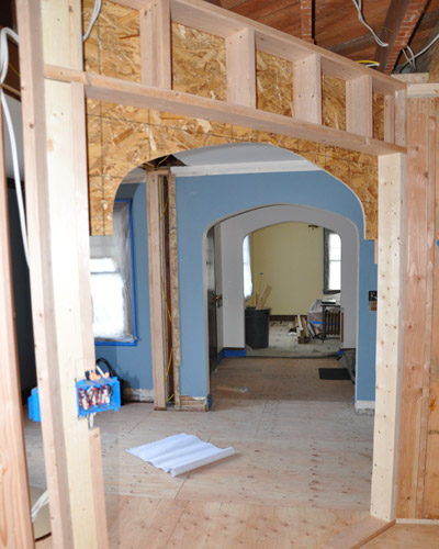 A new diagonal arch connects the kitchen to the dining room.  After mocking it up during construction, a decision was made to reduce the size of the island to keep it from encroaching on the opening