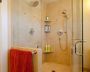 Sheer luxury in the master shower:  two shower heads and a frameless glass enclosure up to beautifully tiled walls