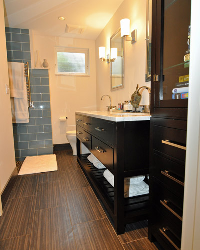 After: A spacious bath and closet with enough room for a furniture storage piece at the entry.