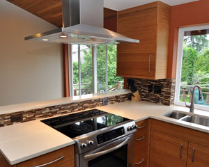 The island hood became a major feature of the kitchen.  The stove was previously on the opposite wall, and by moving it to a peninsula the stove becomes a focal point in the kitchen