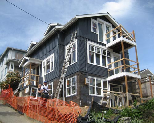 The new second floor is a complete master suite remodel with full bath and its own balcony, a major home addition seattle