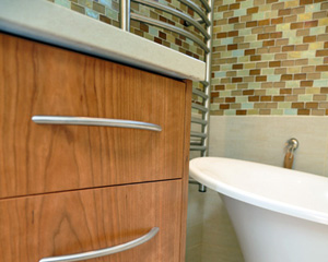 The heated towel bar to the left is on a timer and shows off nicely against the tile and warm wood tones