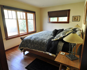 A light-filled master bedroom looks out on the fenced backyard - private but spacious.