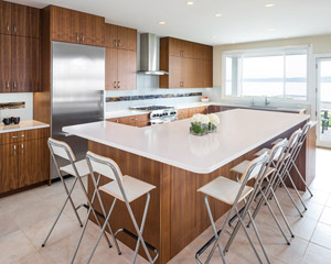 The island is also in walnut, with quartz Pental Lattice countertops to match, and installed in a waterfall style at the raised counter