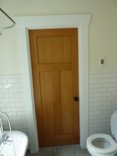A lingering concern as the project was planned was how to eliminate the old door into the bedroom.  It was in the middle of a room with tile wainscot and it was unclear if that or the floor tile could be located