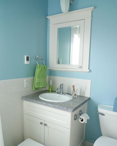 The kids bath is also remodeled.  Again, there are custom cabinets for the vanity and a medicine cabinet, but this time in a style traditional for this West Seattle Tudor home.   The terrazzo countertop has blue accents, picking up the color of the walls