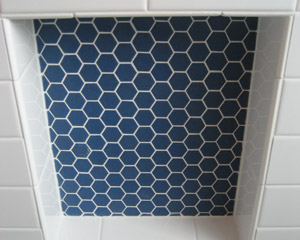 The niche is a deep blue hex tile.  The balance is simple subway tile. Seattle custom hexagon tile