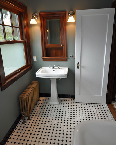 On the kids' side, a small closet and some hall space were captured to create an amazing large bathroom.  The sink is salvaged, and the original radiator reinstalled.  Two new mahogany windows match the same details as in the master bath