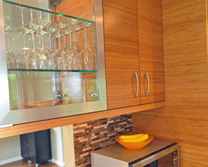 Under-cabinet lighting at the upper cabinets with glass fronts on both sides sheds light on the task counters below..  The Puc lights inside those cabinets also illuminate stemware from each room